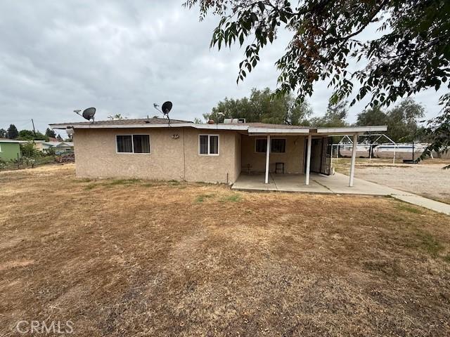 24062 Eucalyptus Ave, Moreno Valley, CA 92553 - back of house with a patio area and stucco siding