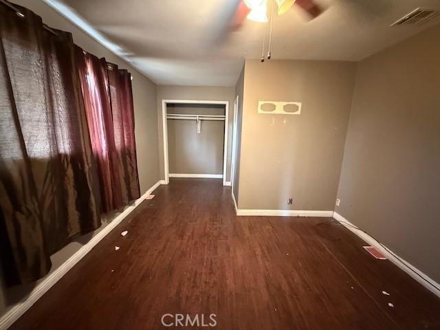 24062 Eucalyptus Ave, Moreno Valley, CA 92553 - unfurnished bedroom featuring baseboards, ceiling fan, wood finished floors, and visible vents