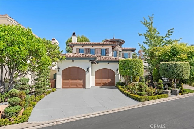 mediterranean / spanish-style house featuring a garage