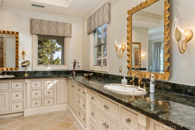 bathroom with tile patterned floors and vanity