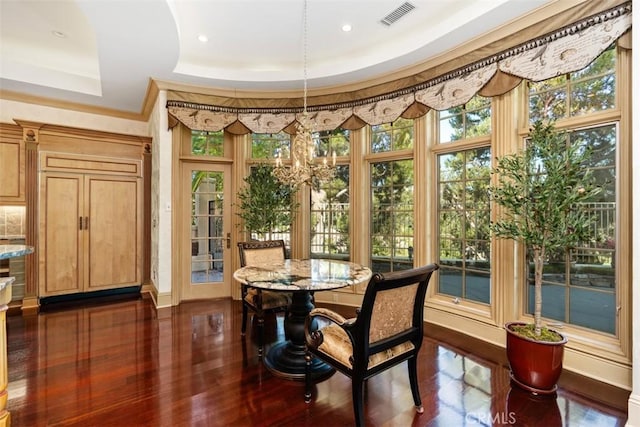 sunroom / solarium featuring a tray ceiling