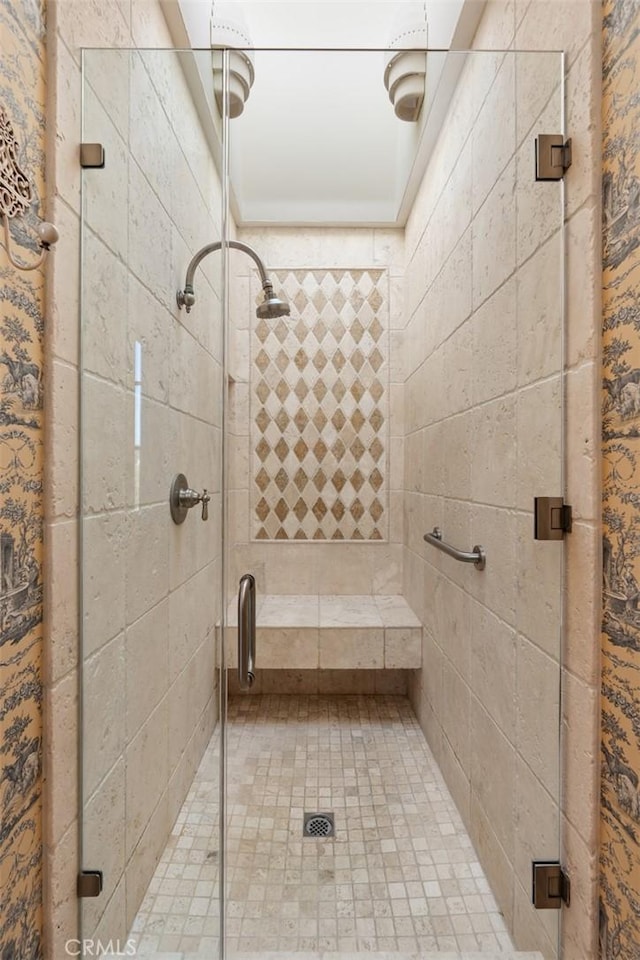 bathroom featuring a shower with door