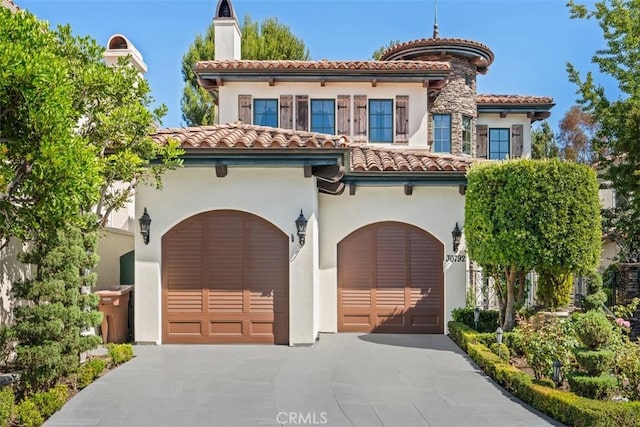 mediterranean / spanish-style house with a garage