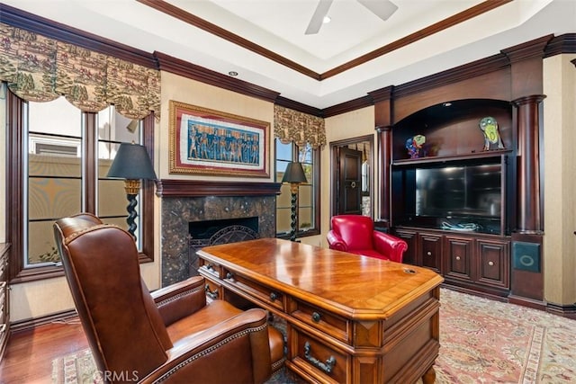 living room with hardwood / wood-style floors, ceiling fan, ornamental molding, and a fireplace