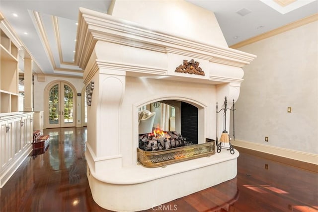 interior space featuring french doors, hardwood / wood-style flooring, ornamental molding, and a premium fireplace