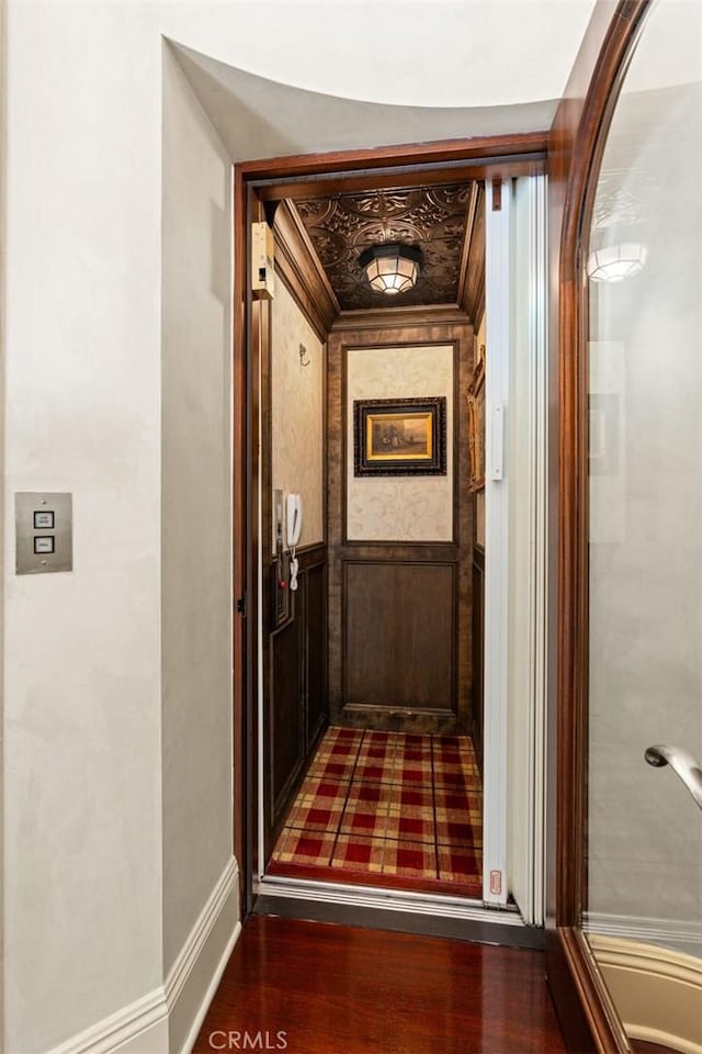 corridor with dark hardwood / wood-style floors