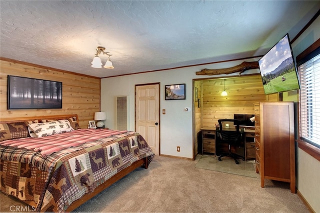 carpeted bedroom with a textured ceiling and wood walls