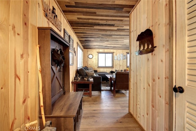 interior space featuring hardwood / wood-style flooring, wood walls, and wooden ceiling