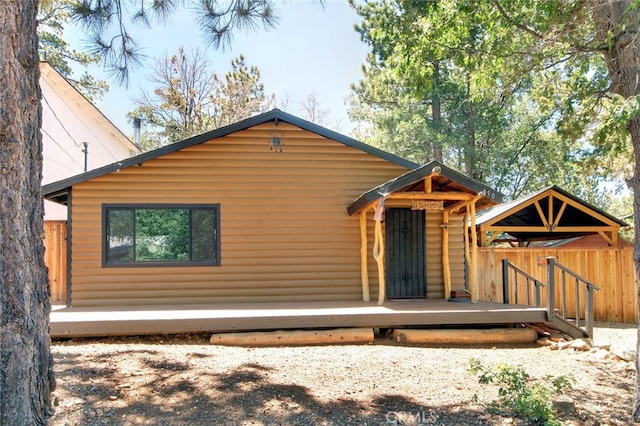 rear view of house featuring a wooden deck