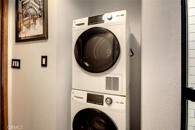 laundry room featuring stacked washer and dryer