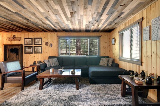 living room featuring wood-type flooring, wooden walls, and plenty of natural light