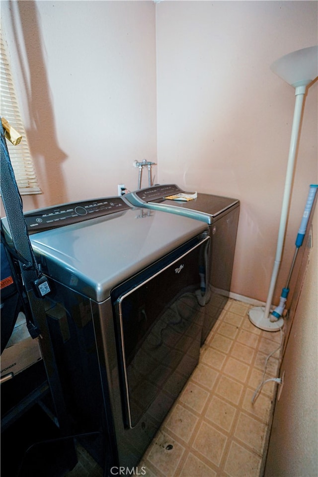 clothes washing area with washing machine and clothes dryer