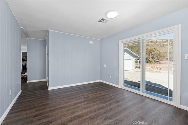 unfurnished room with dark hardwood / wood-style floors and wood walls