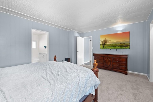 carpeted bedroom featuring ensuite bath