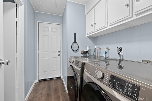 laundry room featuring dark hardwood / wood-style flooring, washer and dryer, and cabinets