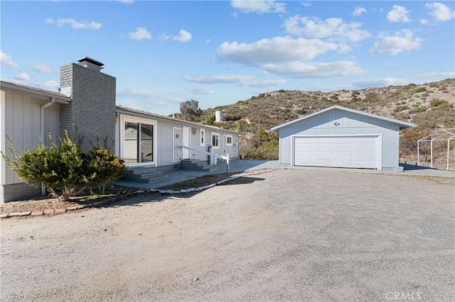 view of side of property with a garage and a mountain view