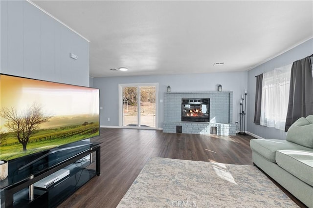 living room with a fireplace and dark hardwood / wood-style flooring