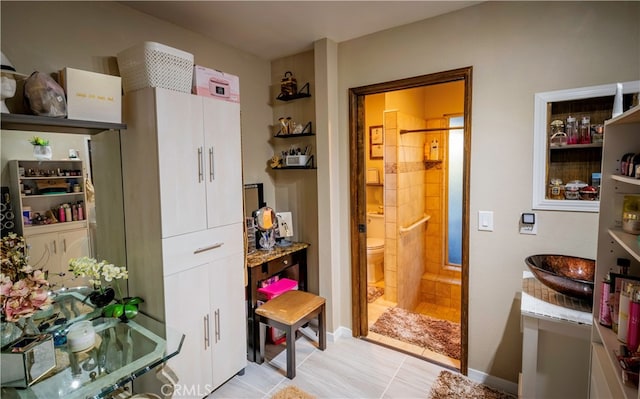 interior space with tile patterned flooring and toilet