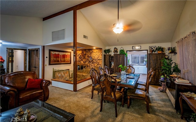 carpeted dining space featuring ceiling fan, a textured ceiling, and high vaulted ceiling