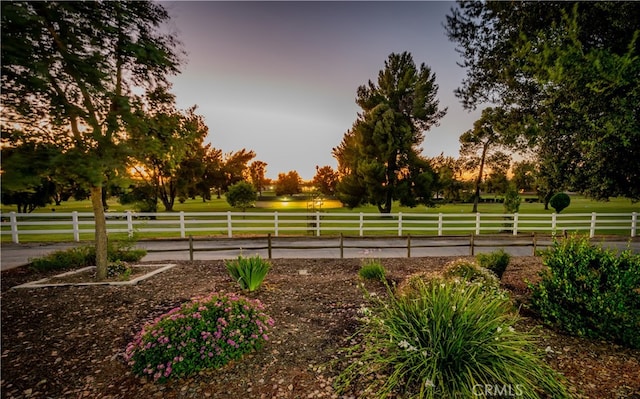 view of community featuring a rural view and a lawn