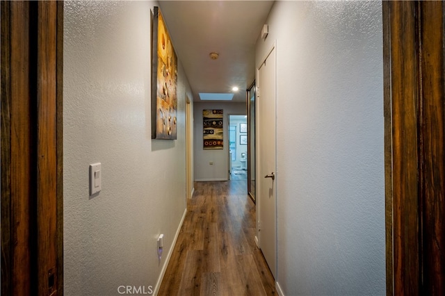 hallway with hardwood / wood-style floors