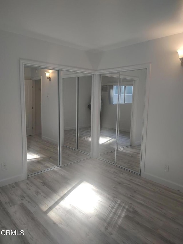 unfurnished bedroom with light hardwood / wood-style floors