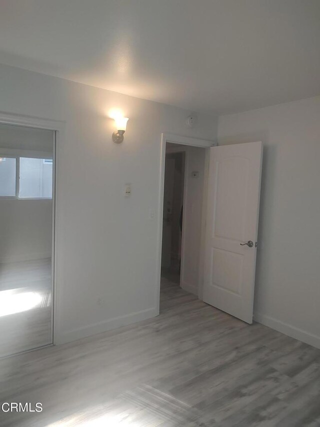 spare room featuring light hardwood / wood-style flooring