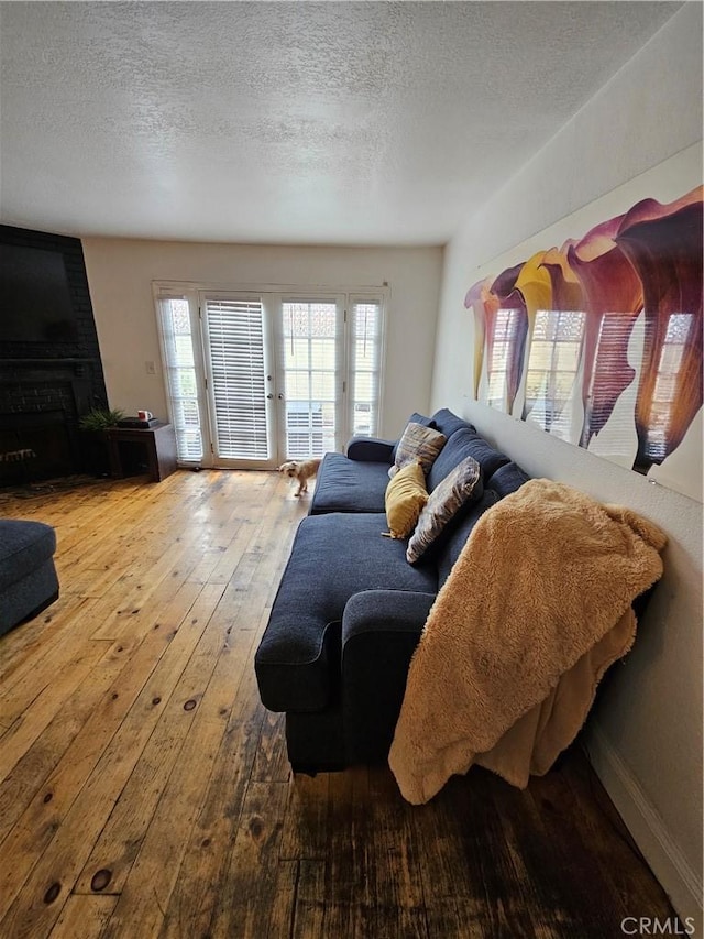 living room with hardwood / wood-style flooring and a textured ceiling