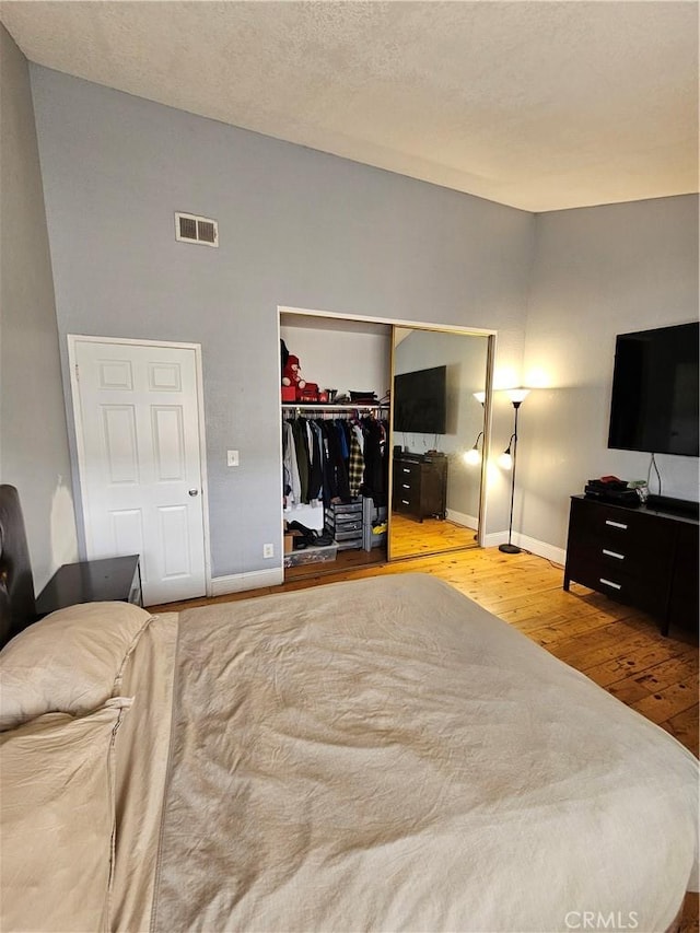 bedroom featuring light hardwood / wood-style flooring and a closet