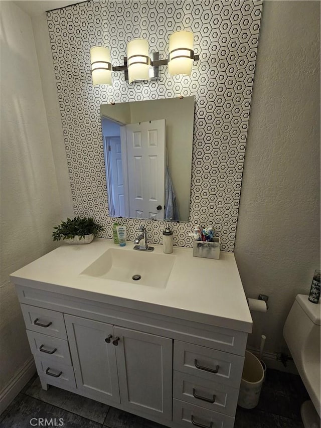 bathroom featuring vanity and toilet