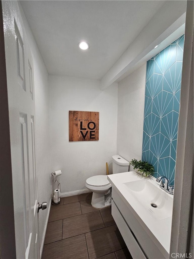 bathroom featuring vanity and toilet