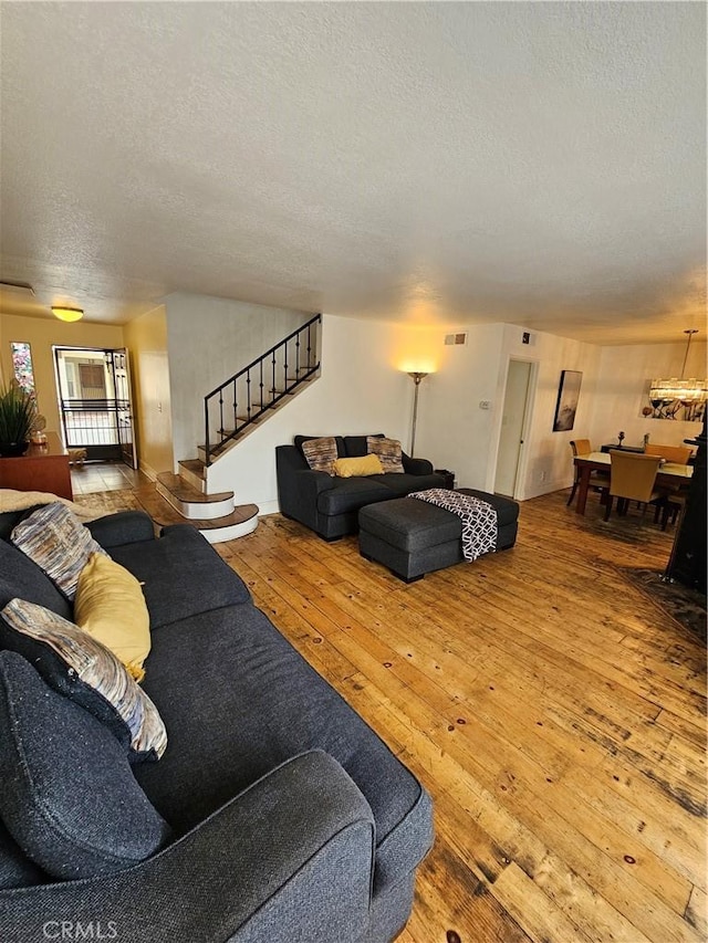 living room with wood-type flooring and a textured ceiling