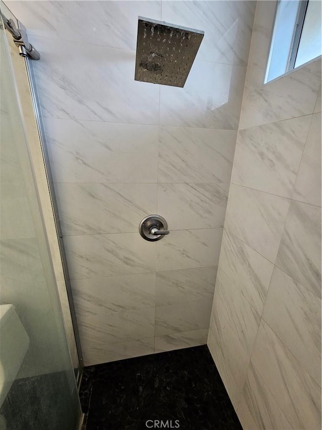 bathroom with a tile shower