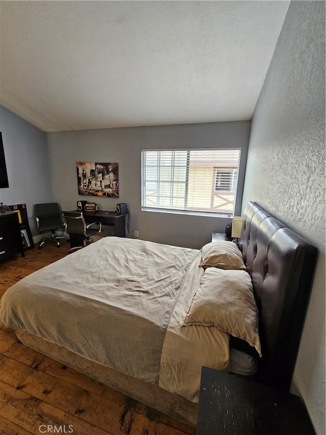 bedroom with wood-type flooring