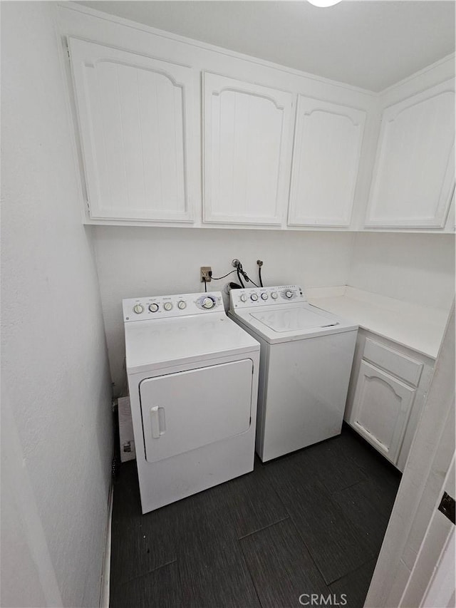 laundry area with washer and dryer and cabinets