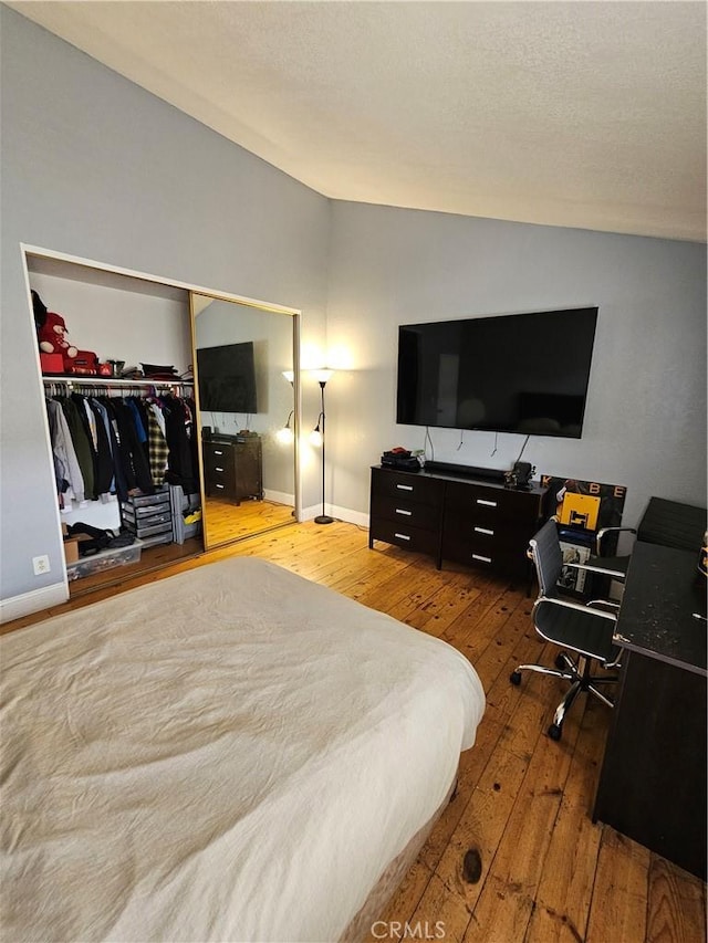 bedroom with a closet and hardwood / wood-style floors