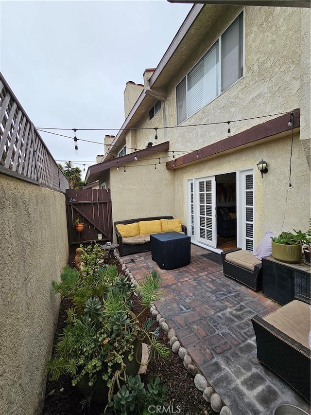 back of house featuring a patio and an outdoor hangout area