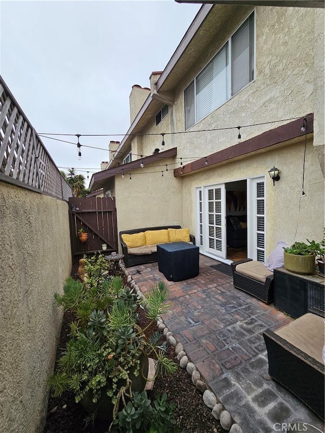 view of patio / terrace featuring outdoor lounge area and fence