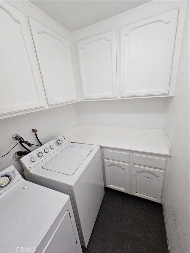 laundry room featuring washer and clothes dryer and cabinet space