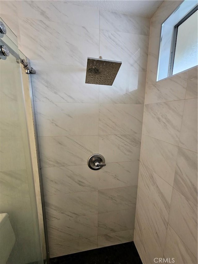 bathroom with a tile shower