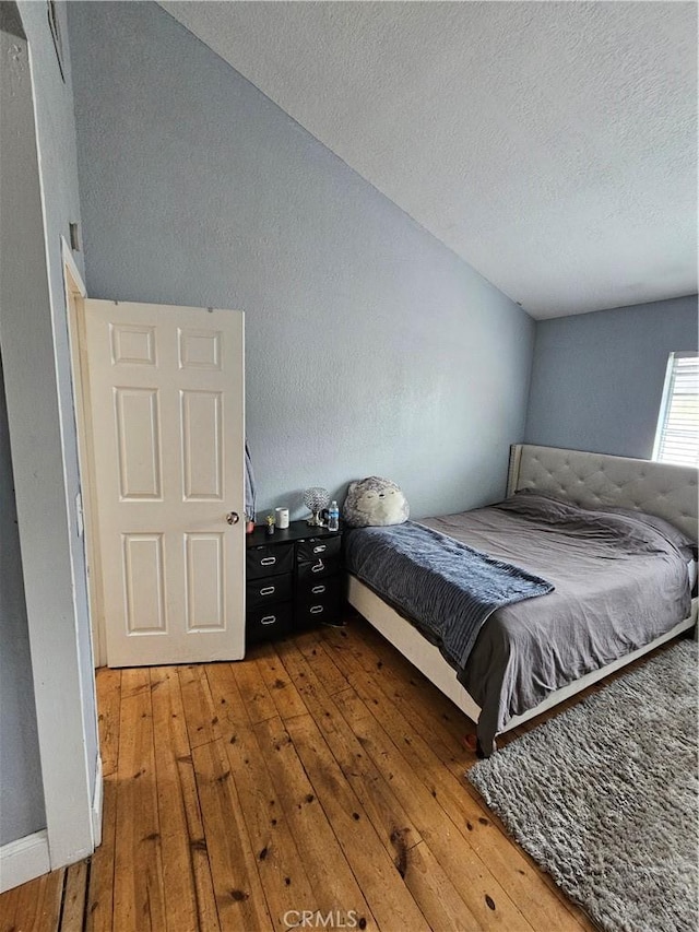 bedroom featuring hardwood / wood-style floors and a textured ceiling