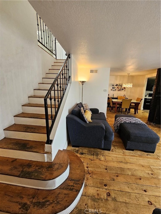 living room with hardwood / wood-style floors and a textured ceiling