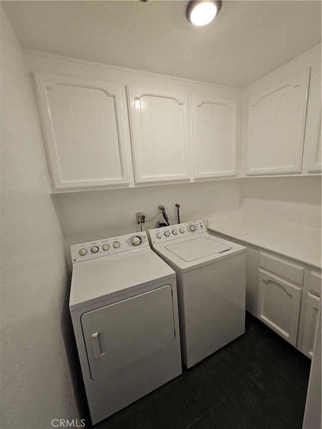 laundry room with washer and clothes dryer, cabinet space, and dark wood-type flooring