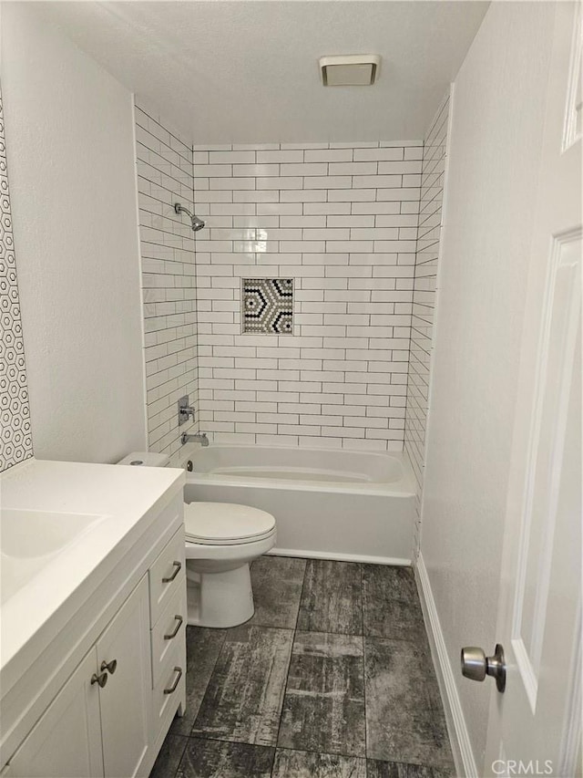 full bath featuring vanity, toilet, and washtub / shower combination