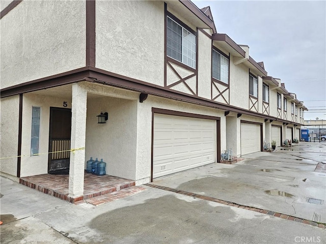 view of home's exterior featuring a garage, driveway, and stucco siding