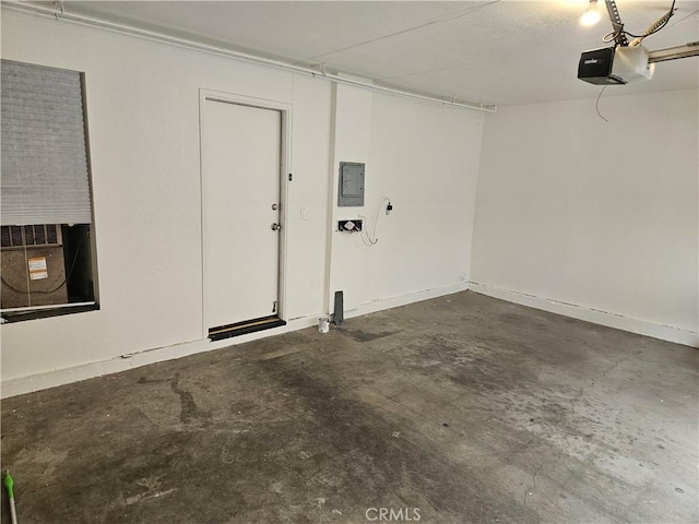 13921 Kornblum Unit 9, Hawthorne, CA 90250 - garage featuring a garage door opener, baseboards, and electric panel