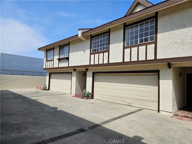 13921 Kornblum Unit 9, Hawthorne, CA 90250 - view of front of house featuring concrete driveway, a garage, and stucco siding