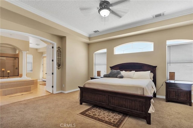 carpeted bedroom featuring a textured ceiling, ornamental molding, ceiling fan, and ornate columns