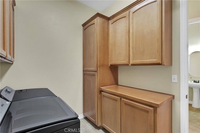 laundry area with cabinets and washing machine and dryer