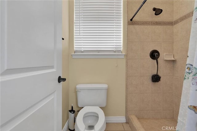 bathroom featuring tile patterned flooring, toilet, and a shower with curtain